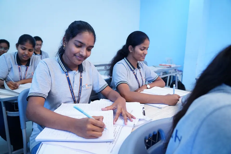 A student smiling while studying in class