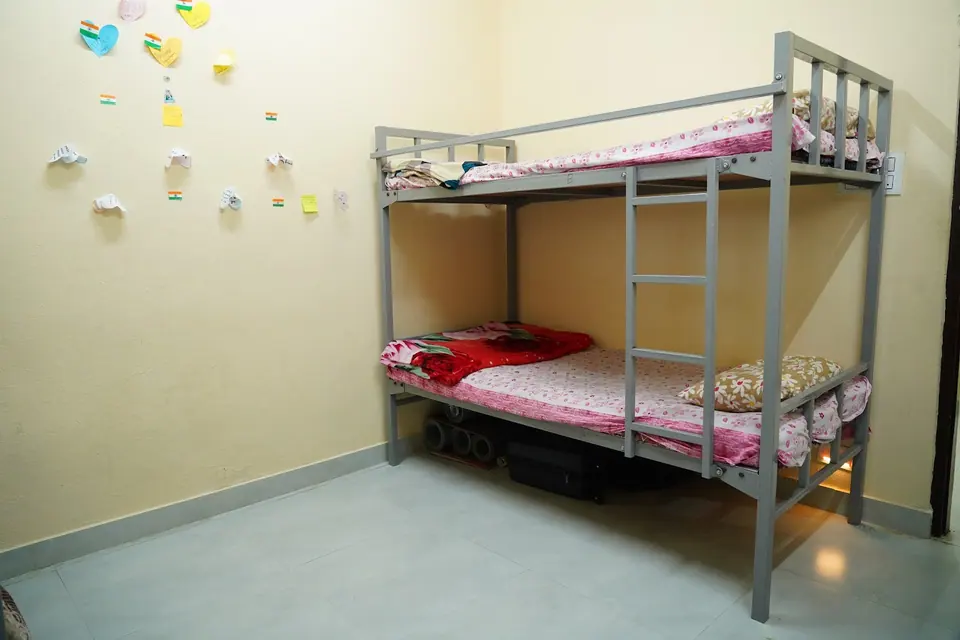 A hostel room with a bunk bed