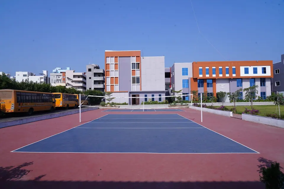 The volleyball court with the campus behind